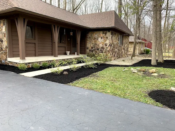 A house with a driveway and a lot of grass